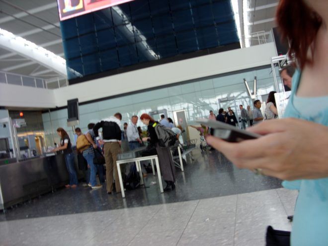 Blurry photograph of a profile of Blowtooth player in airport security area