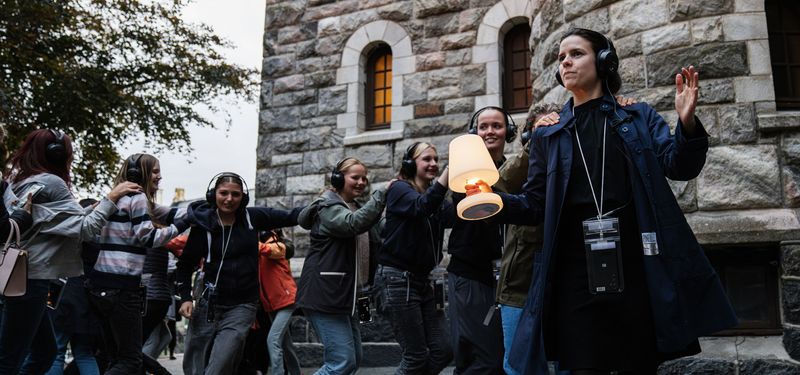 Outdoors, a group of audience members dances along with one of the characters