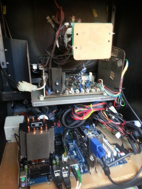Blurry photo of the PC electronics inside an arcade machine