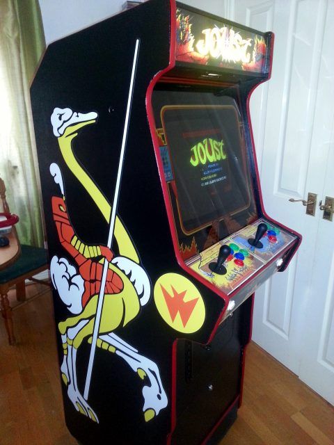 Photo of the finished arcade machine, with Joust artwork on the side, playing Joust