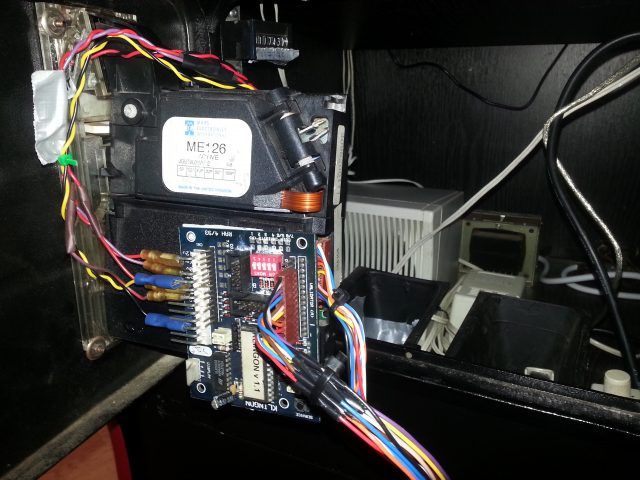 Photo of the interior of the coin mechanism, showing a circuit board and an analogue counter